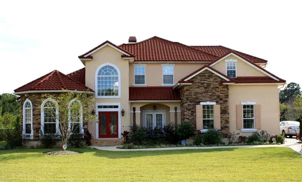 Completed red tile roof on a stucco home