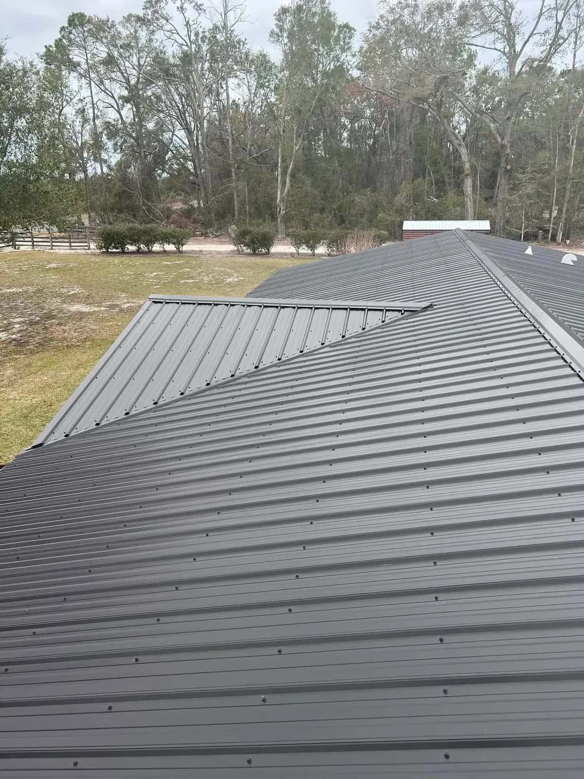 Close view of ridge and valley details on a gray metal roof