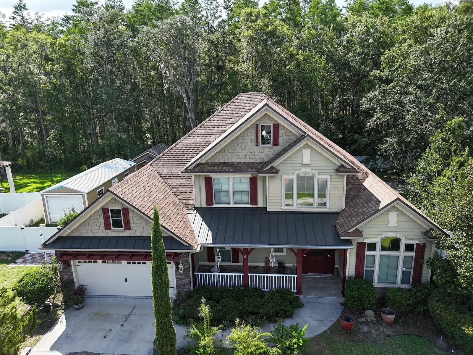 Wood-sided home with a multi-plane brown architectural shingle roof