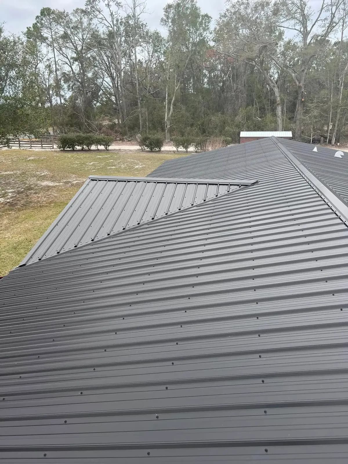 Close view of ridge and valley details on a gray metal roof